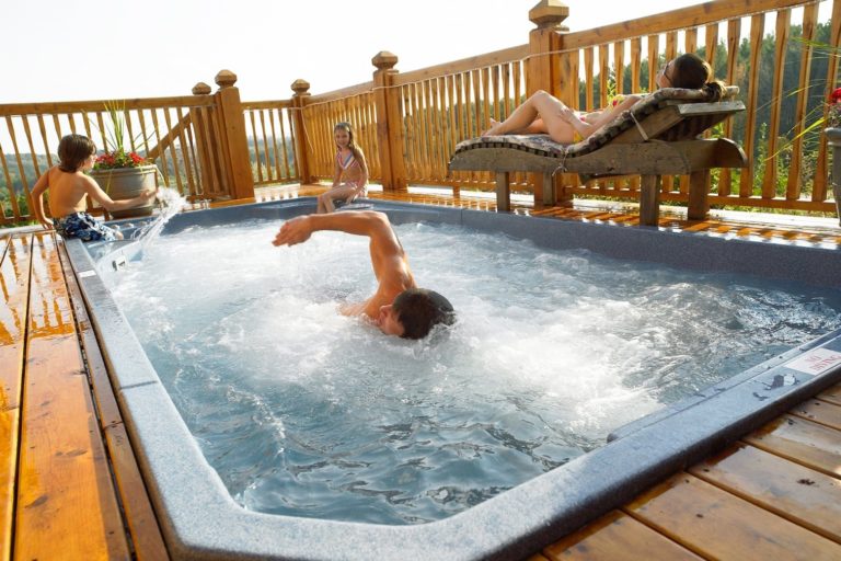 Family enjoying their Hydropool Swim Spa outside on the deck